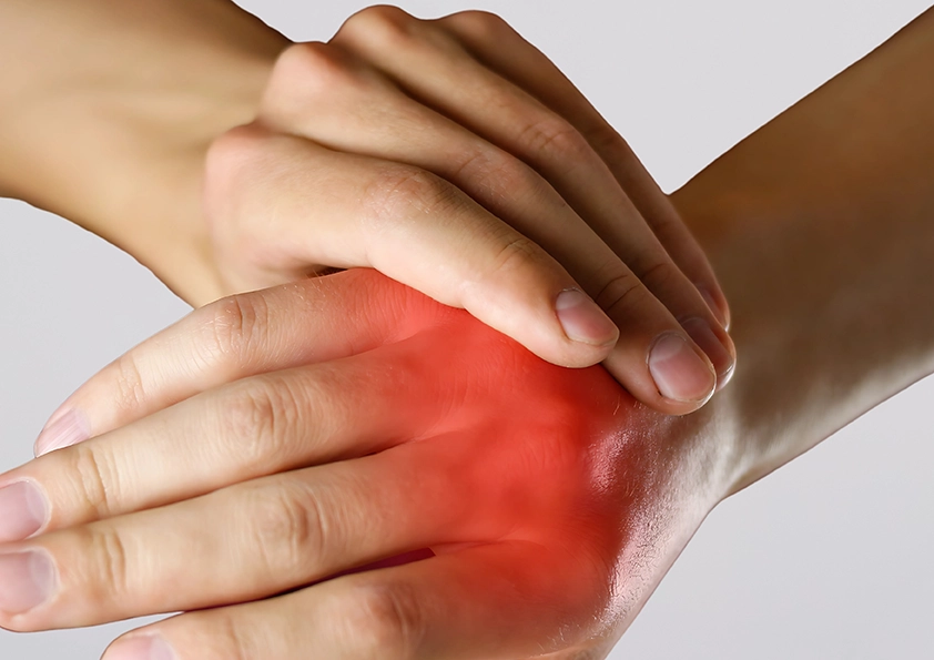 Person experiencing joint pain in the hands.